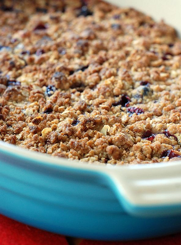 white plate with rhubarb blackcurrant crumble