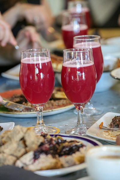three glasses of blackcurrant beer standing on a table