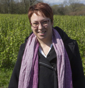 IBA General Manager Stefanie Sharma standing in a blackcurrant field