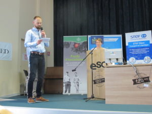 representative from Poland standing on a stage sharing blackcurrant statistics during a conference