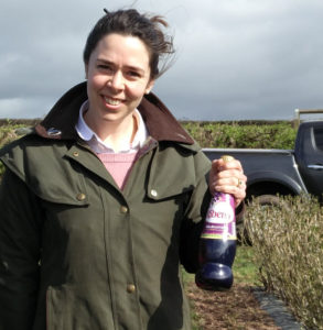 Harriet Prosser, LRS, holding a bottle of Ribena. She is part of the project for climate-resilient blackcurrant varieties.