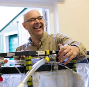 Dr Mark Willems standing in his lab and laughing